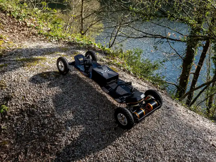 AXIS Pro 2026 Evo-Spirit electric mountainboard overlooking a pond